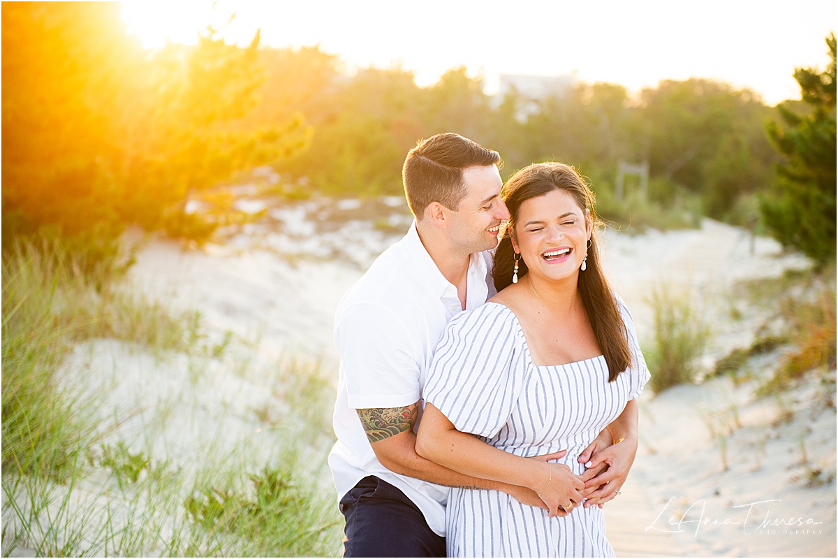 couple laughs at sunset in Barnegat Light engagement photos