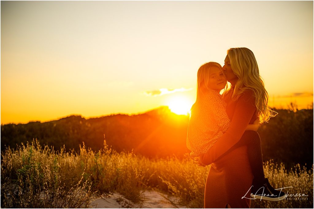 mother and daughter hug in sunset photo on beach lbi