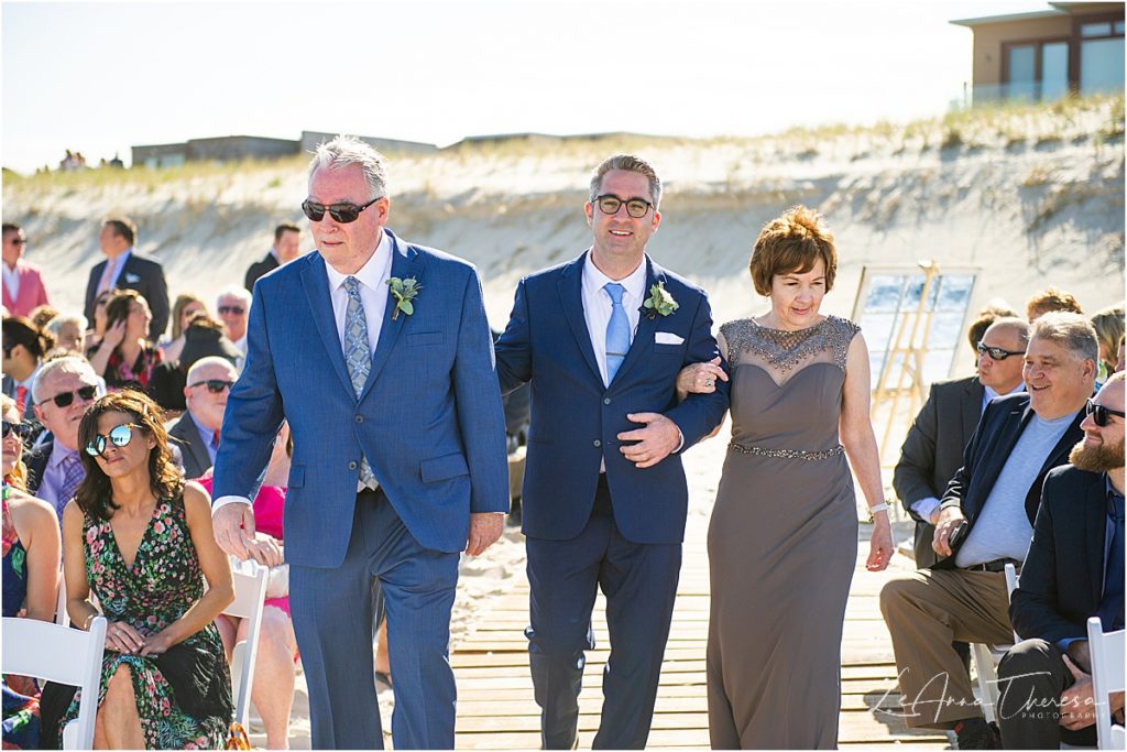 groom and parents at beach wedding